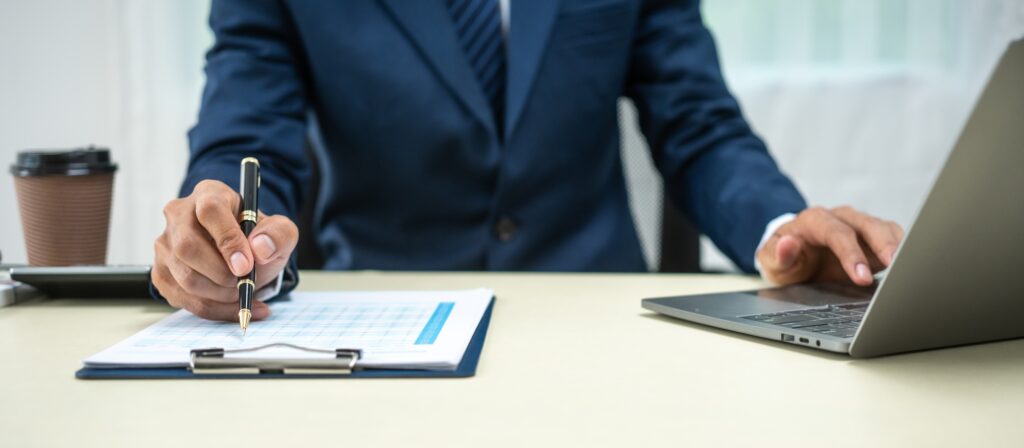 banker in a suit works at a desk handling loans, analyzing client financial data, providing